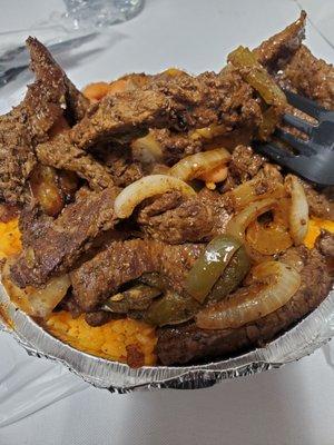 Pepper steak, yellow rice, beans, and two little plantains somewhere on here.