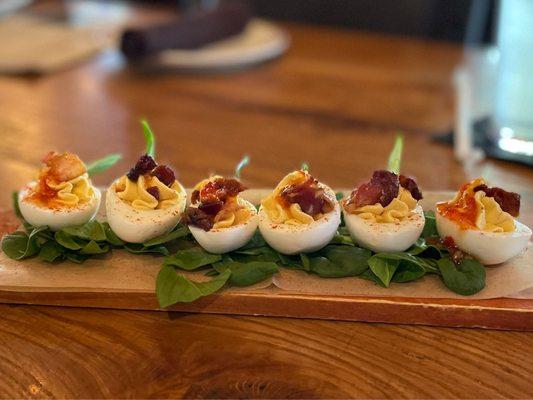 Deviled eggs with bacon and sweet siracha drizzle!