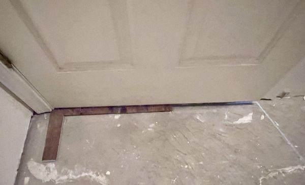 Flooring cut horribly along door and no transition