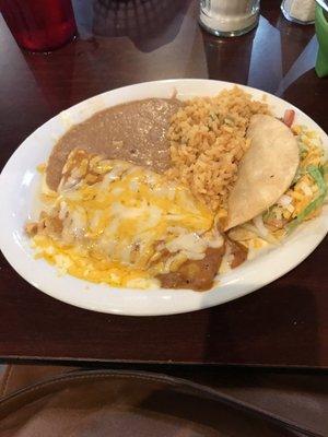 Texan plate with chicken enchiladas covered in gravy with crispy beef taco. Rice and beans. All very, very good!