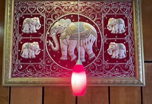 Art and lighting above booth table