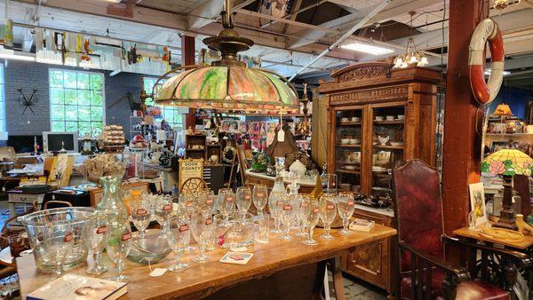 Barware under antique stained glass light fixture that was converted to electric from gas.