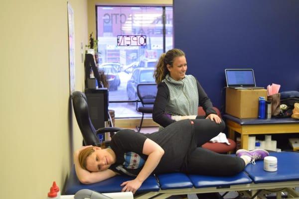 Jenn Meeting, PT, DPT,  performing physical therapy exercises with a patient.