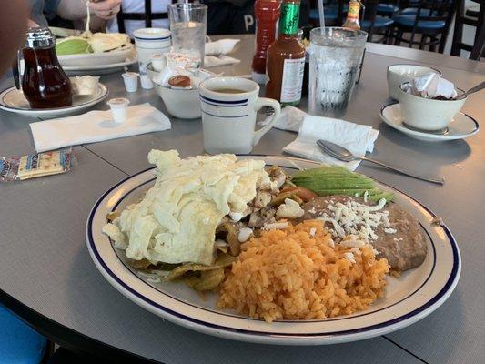 Delicious chicken chilaquiles, with  beans, rice, egg whites and avocado. I recommend the green salsa.