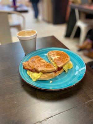 the new yorker sandwich (bacon egg and cheese on a bagel) and a cafe bombón