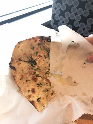 Best garlic naan bread I've ever had. Slathered in oil and garlic and baked. Oh man...