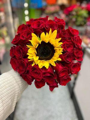 Roses and a sunflower .