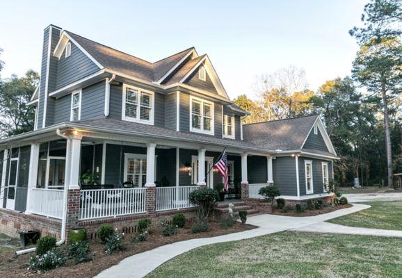 This house had big trees in the front removed, Roof, Siding, Windows, Front porch, fence, concrete path ways, asphalt driveway, garage epoxy