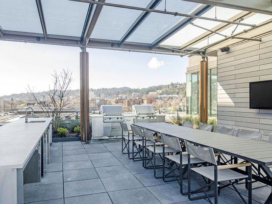 Covered, outdoor room to host and grill on the rooftop.