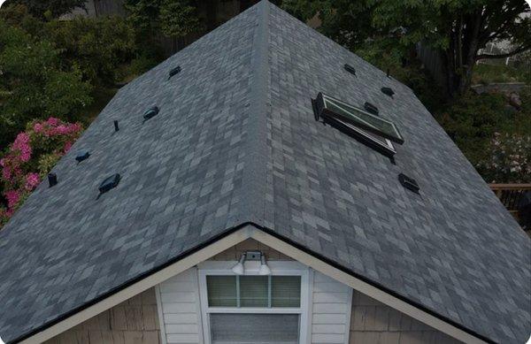 Asphalt shingle roof with skylight window installation