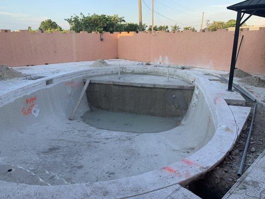 They demoed the old pool and are in the process of adding a tanning ledge