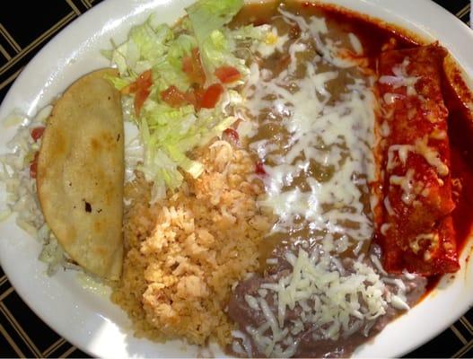 Chicken taco, chile relleno, enchilada plate with rice and beans