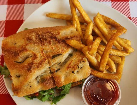 salmon sandwich on store made focaccia served with excellent fries.