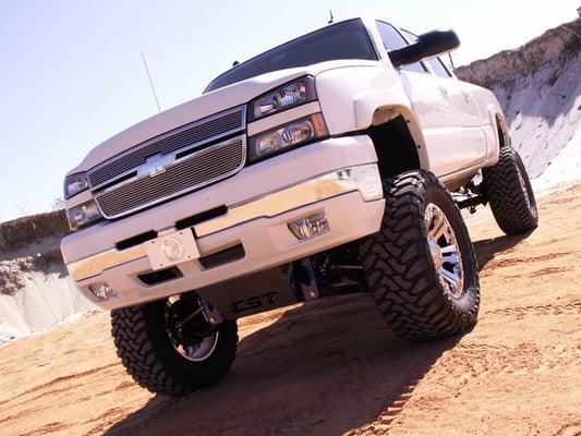 Lifted Chevrolet truck with tires and wheels installed by Cypress Tire Company