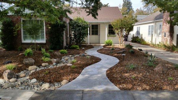 Front Yard renovation with new walkway, dry creek bed, plants and rock.