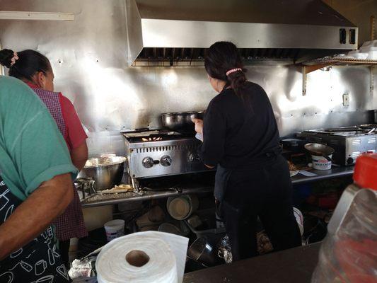 Ladies busy at the stove preparing the Sunday meals