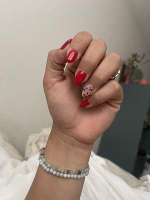 Short acrylic nails with cherry design .