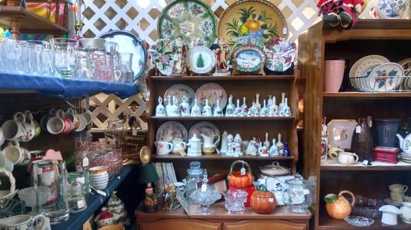 Decorative dishes and a collection of porcelain bells.