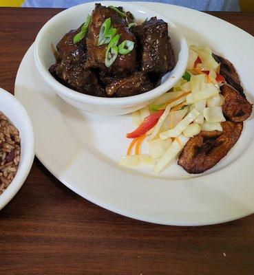 Jerk chicken, cabbage and plantains, and rice and beans.