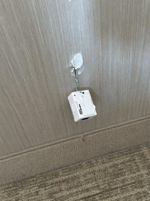 Plug hanging from the wall