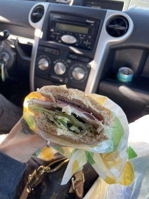 Turkey and salami with lettuce and pickles on wheat.