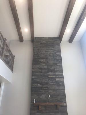 stone fireplace, ceiling beams, railings