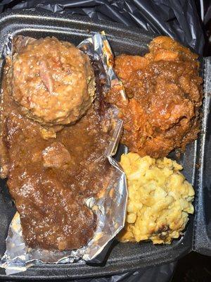 Smothered pork steak, macaroni and cheese, Candi yams, cornbread stuffing