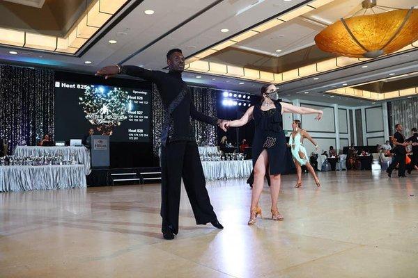 Instructor Hugues dancing with his student in competition