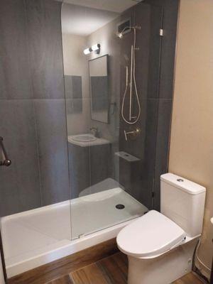 Remodeled bath with shower and toilet