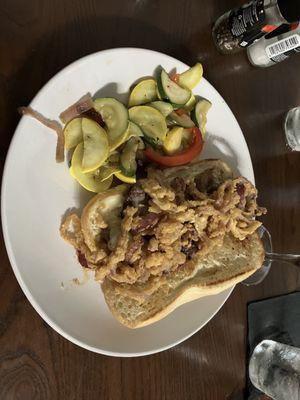 Steak sandwich with sautéed veggies.