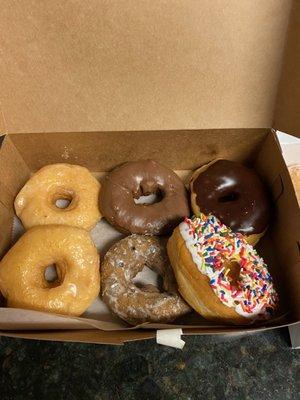 Left to right: 2 glazed, hard chocolate, blueberry, chocolate frosted and vanilla frosted with sprinkles