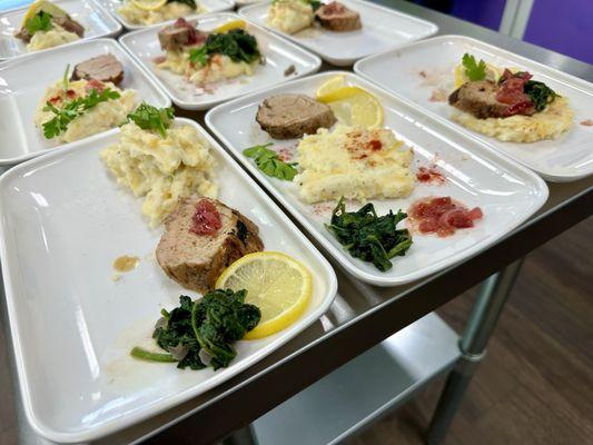 Perfectly cooked pork loin with creamy mashed potatoes & seasoned spinach.