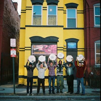 The 7DrumLessons team right outside our unique and funky building. Look at those drums!!