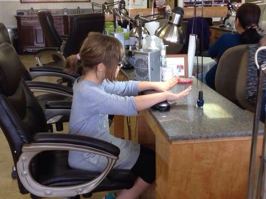 Getting her nails painted for her birthday dinner.