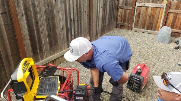 Video inspection while descaling a cast iron pipe underneath the home.