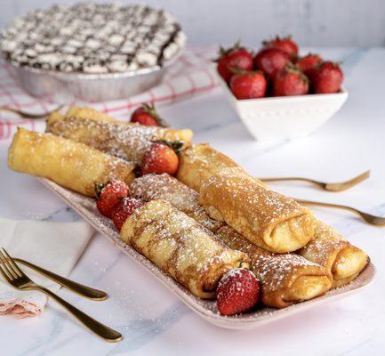 Our homemade blintzes topped with strawberries & powdered sugar