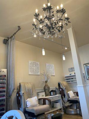 Pedicure chairs and sparkling chandelier