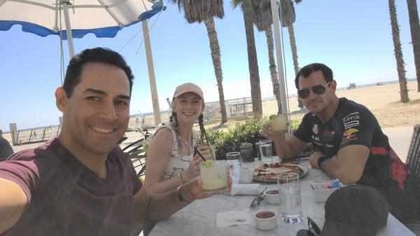 The best burger on the boardwalk, hand down. On the table are skinny margaritas and a margarita pizza.