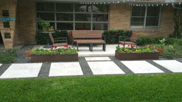 Modern stone patio design with travertine tiles and gray crushed granite