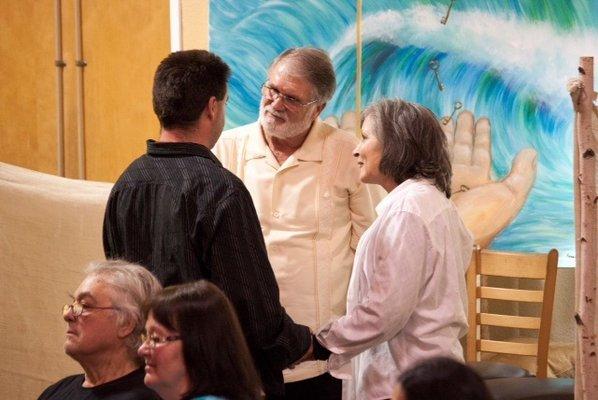 Pastor Bobby and Margo Praying with loved ones