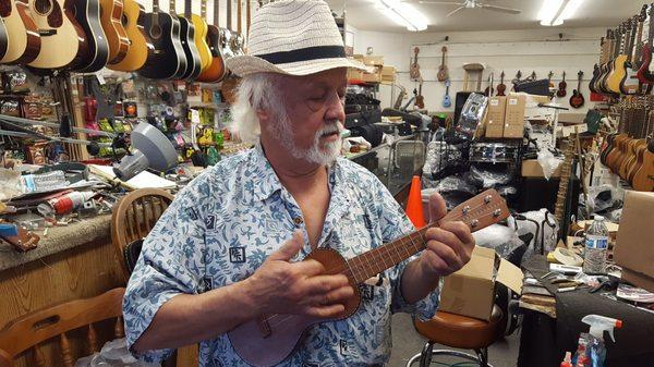 Jim playing his dad's Koa ukelele