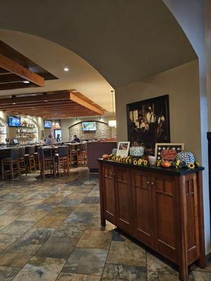 The entrance to the bar and one of the seating areas of the restaurant and the table where the mints are located for  when you leave.