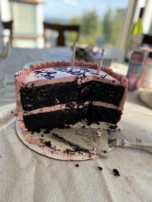 The cross section of the chocolate cake with raspberry buttercream.