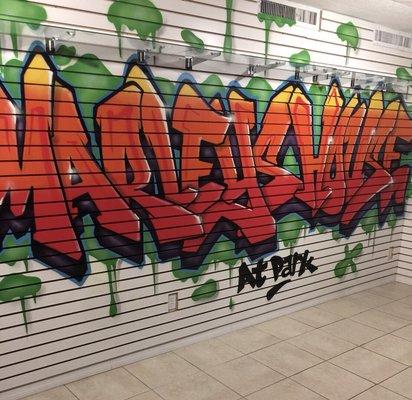 Graffiti tag art mural featured inside the store