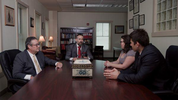 The Montagna Law team of personal Injury attorneys discussing a personal injury case at the office in Virginia Beach.