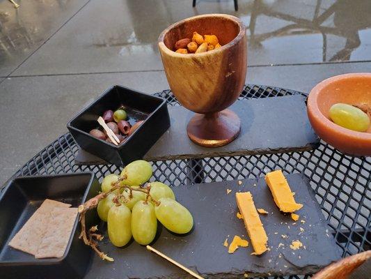 Olive and nice spiced nut mixture, grape & cheddar plate. Gouda was eaten by time shot taken, happy hour,