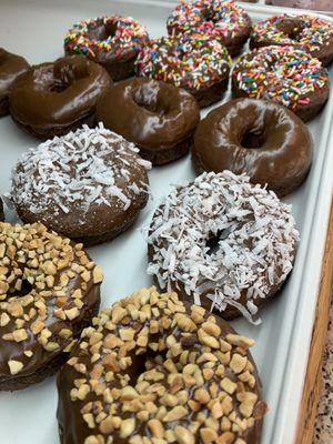 Assorted devils food cake donuts.