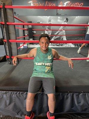 Manuel sitting in front of the ring after boxing class.