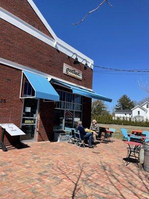 Outdoor seating with picnic tables on the side of the building