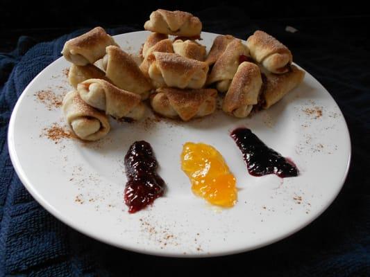 Rugulah: Pastry bites that are handmade one piece at a time. Rolled out, cut, filled, and baked golden brown.